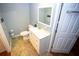 Bathroom features a modern white sink with vanity, a toilet, and a storage shelf at 6147 Pritchett Dr, Powder Springs, GA 30127