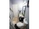 Compact bathroom featuring a toilet, vanity with granite countertop, and neutral tiling at 6147 Pritchett Dr, Powder Springs, GA 30127