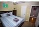 Cozy bedroom features a comfortable bed and a view into an adjacent room at 6147 Pritchett Dr, Powder Springs, GA 30127