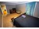 Bedroom with neutral walls, carpet flooring, and a window with blue curtains at 6147 Pritchett Dr, Powder Springs, GA 30127