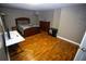 Cozy bedroom features hardwood floors, a comfy bed, and a workspace for added convenience at 6147 Pritchett Dr, Powder Springs, GA 30127