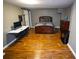 Bedroom with hardwood floors, gray walls, and a sliding barn door at 6147 Pritchett Dr, Powder Springs, GA 30127