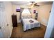 Bedroom with comfortable bed, ceiling fan, dresser and colorful wall decor at 6147 Pritchett Dr, Powder Springs, GA 30127