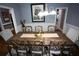 Traditional dining room with wooden table set, wainscoting, and decorative wall art at 6147 Pritchett Dr, Powder Springs, GA 30127