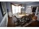 Charming dining area with large windows, chandelier, and seating for eight at 6147 Pritchett Dr, Powder Springs, GA 30127