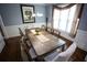 Bright dining room with a wooden table, six chairs, and natural light streaming through a large window at 6147 Pritchett Dr, Powder Springs, GA 30127