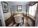 Elegant dining room featuring a large wooden table, decorative rug, and natural light from the window at 6147 Pritchett Dr, Powder Springs, GA 30127