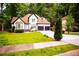 Beautiful two-story home with an attached two-car garage and green lawn at 6147 Pritchett Dr, Powder Springs, GA 30127