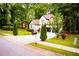 Beautifully landscaped front yard featuring lush greenery and a long driveway at 6147 Pritchett Dr, Powder Springs, GA 30127
