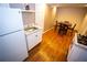 Kitchen with white cabinets, modern appliances, and a dining table with four chairs at 6147 Pritchett Dr, Powder Springs, GA 30127