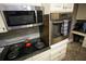 Modern kitchen with stainless steel microwave and oven, as well as stylish backsplash at 6147 Pritchett Dr, Powder Springs, GA 30127