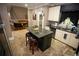 Modern kitchen features an island with seating, granite countertops, and stainless steel appliances at 6147 Pritchett Dr, Powder Springs, GA 30127