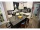 Cozy kitchen boasts an island with seating and stylish pendant lighting at 6147 Pritchett Dr, Powder Springs, GA 30127