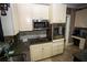 Galley kitchen features stainless steel appliances, granite countertops, and ample storage at 6147 Pritchett Dr, Powder Springs, GA 30127
