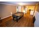Spacious living room with hardwood floors, a ping pong table, and kitchenette at 6147 Pritchett Dr, Powder Springs, GA 30127
