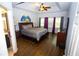 Spacious main bedroom boasts hardwood floors, a tray ceiling, and generous natural light at 6147 Pritchett Dr, Powder Springs, GA 30127