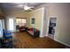 Spacious sunroom with wood flooring, comfortable seating, and a ceiling fan for air circulation at 6147 Pritchett Dr, Powder Springs, GA 30127
