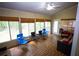 Comfortable sunroom with hardwood floors and access to the backyard at 6147 Pritchett Dr, Powder Springs, GA 30127