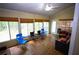 Inviting sunroom filled with natural light, featuring wood flooring and a cozy seating area at 6147 Pritchett Dr, Powder Springs, GA 30127