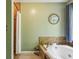 Relaxing bathroom featuring a garden tub and a decorative tree art piece on the wall at 682 Leighton Way, Stone Mountain, GA 30088
