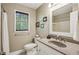 Cozy bathroom featuring a granite countertop vanity, a window and tiled flooring at 682 Leighton Way, Stone Mountain, GA 30088