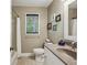 Cozy bathroom featuring a granite countertop vanity, a window and tiled flooring at 682 Leighton Way, Stone Mountain, GA 30088