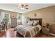 Comfortable bedroom with neutral tones, hardwood floors, and ceiling fan at 682 Leighton Way, Stone Mountain, GA 30088