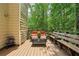 Inviting wooden deck with benches and seating surrounded by lush greenery at 682 Leighton Way, Stone Mountain, GA 30088