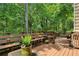 Spacious wooden deck with bench seating overlooking a private, wooded backyard at 682 Leighton Way, Stone Mountain, GA 30088