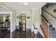 Inviting entryway with hardwood floors, a crystal chandelier, and staircase access at 682 Leighton Way, Stone Mountain, GA 30088