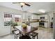 Well-lit kitchen with white cabinets, granite countertops, and a tile floor at 682 Leighton Way, Stone Mountain, GA 30088