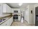 Clean kitchen with stainless steel appliances, granite countertops, and ample storage at 682 Leighton Way, Stone Mountain, GA 30088