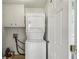 Laundry room equipped with stacked washer and dryer units at 682 Leighton Way, Stone Mountain, GA 30088