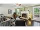 Comfortable living room with a brick fireplace, hardwood floors, and a door to the outside at 682 Leighton Way, Stone Mountain, GA 30088