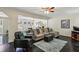 Spacious living room featuring hardwood floors and a comfortable sectional sofa at 682 Leighton Way, Stone Mountain, GA 30088