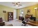Office space with a desk, computer, and a couch for relaxation and creative work at 682 Leighton Way, Stone Mountain, GA 30088