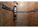 Tiled shower space equipped with a sleek shower head and convenient shelving at 682 Leighton Way, Stone Mountain, GA 30088
