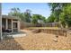 Landscaped backyard with stone retaining wall, stairs, and a screened-in porch at 321 Hickory Sw Walk, Marietta, GA 30064