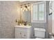 Stylish half-bathroom featuring unique wallpaper, modern fixtures, and ample natural light from the window at 321 Hickory Sw Walk, Marietta, GA 30064