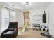 Versatile room featuring recreational equipment, comfortable chair, and bright light from large windows at 321 Hickory Sw Walk, Marietta, GA 30064