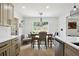 Cozy dining area with modern light fixture and views of the backyard through a bright window at 321 Hickory Sw Walk, Marietta, GA 30064