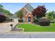 Charming brick and siding home featuring a well-manicured lawn and an inviting blue front door at 321 Hickory Sw Walk, Marietta, GA 30064