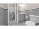 Bathroom featuring a toilet, vanity and sink combination, and a shower with new gray tile at 2740 Pasco Se Ln, Atlanta, GA 30316