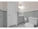 Bathroom featuring a toilet, vanity and sink combination, and a shower with new gray tile at 2740 Pasco Se Ln, Atlanta, GA 30316