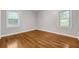 A spacious bedroom is brightened by two sunny windows and offers original hardwood floors at 2740 Pasco Se Ln, Atlanta, GA 30316