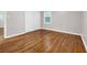 A spacious bedroom is brightened by a sunny window and offers original hardwood floors at 2740 Pasco Se Ln, Atlanta, GA 30316