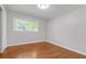 Bright bedroom with hardwood floors, a closet, and a window with a view of the trees at 2740 Pasco Se Ln, Atlanta, GA 30316