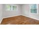 This bedroom features hardwood floors, neutral walls, and two windows that provide natural light at 2740 Pasco Se Ln, Atlanta, GA 30316