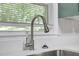 Modern kitchen faucet with a stainless steel finish and a large window providing natural light at 2740 Pasco Se Ln, Atlanta, GA 30316