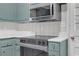 Close-up of the updated kitchen featuring stainless steel microwave, oven, and countertops at 2740 Pasco Se Ln, Atlanta, GA 30316